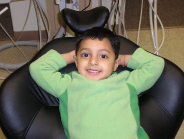 Image of smiling kid in dental office chair
