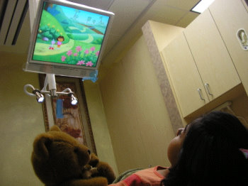 Kid watching TV in dental chair at Fremont Dentist office